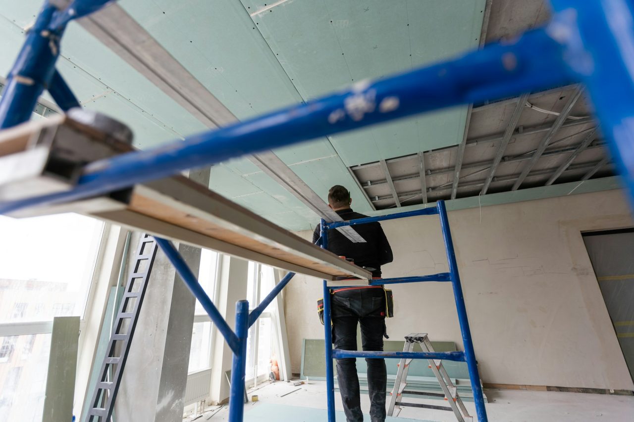 drywall-installers-men-holding-a-gypsum-board-figured-cut.jpg
